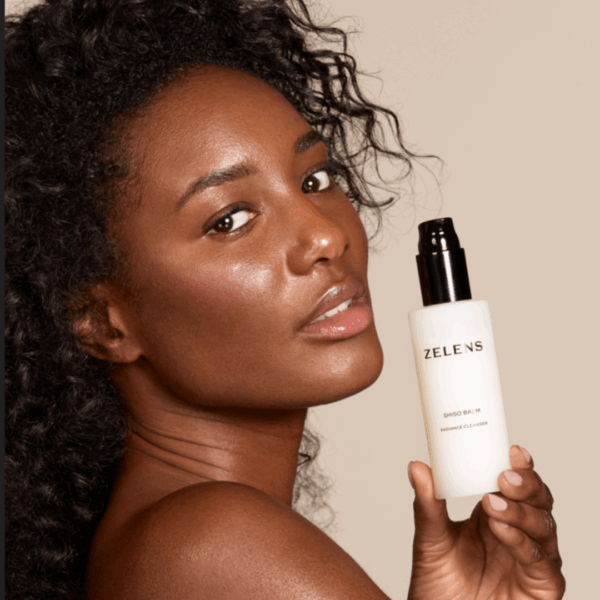 image of the model with zelens shiso balm in her hands
