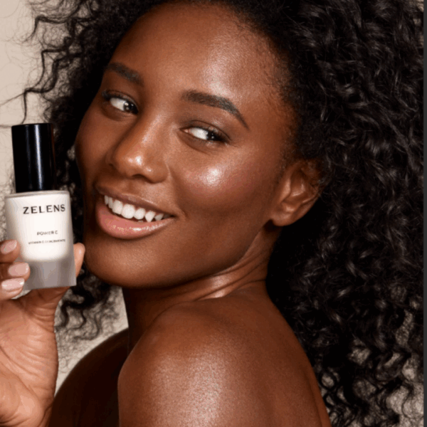 image of the model with zelens power c in her hands