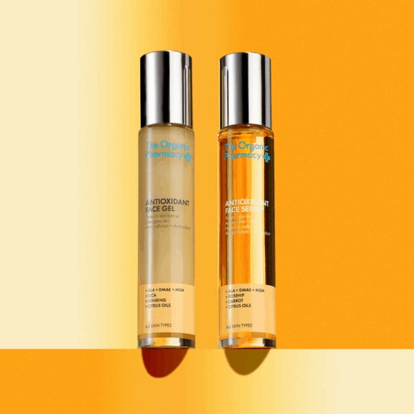 The Organic Pharmacy Antioxidant Duo 2x35ml bottles styled against a vibrant, colorful background emphasizing freshness and vitality