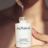 Hand holding Alpha-H Hyaluronic 8 Super Serum 25ml applicator with serum texture visible.
