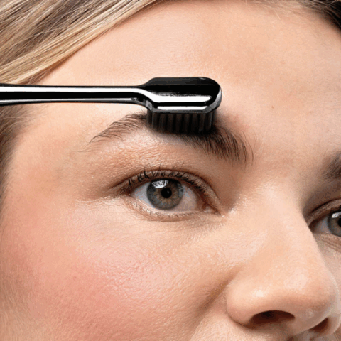 Girl applying M2 Beaute Eyebrow Silk Perfection Balm 5ml to shape, smooth, and style her brows for a polished look.