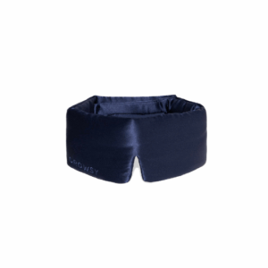 Midnight blue Drowsy silk sleep mask displayed on a soft surface, showcasing its padded design and premium finish.