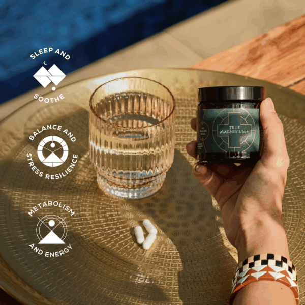 Aesthetic setup featuring a glass of water and Ancient and Brave True Magnesium capsules with highlighted benefits for calm and balance