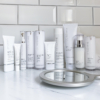 Collection of Teoxane skincare products arranged aesthetically on a neutral background, representing advanced dermocosmetic care