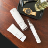 Teoxane Deep Repair Balm 30ml displayed alongside other skincare products, a watch, and aesthetic accessories on a minimal background.