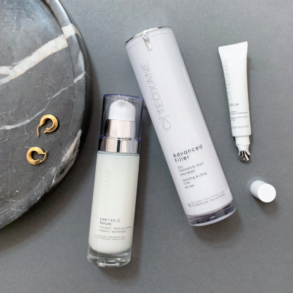 Teoxane RHA Vit C Serum styled with other Teoxane products on an elegant background, highlighting premium skincare aesthetics