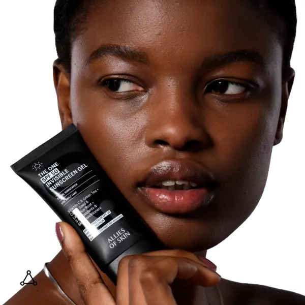 Allies Of Skin The One SPF 50 Invisible Sunscreen Gel 50ml held by woman near face, lightweight broad-spectrum sun protection