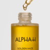 Close-up of Alpha H Golden Haze Face Oil 25ml dropper showing rich golden texture for radiant and nourished skin.