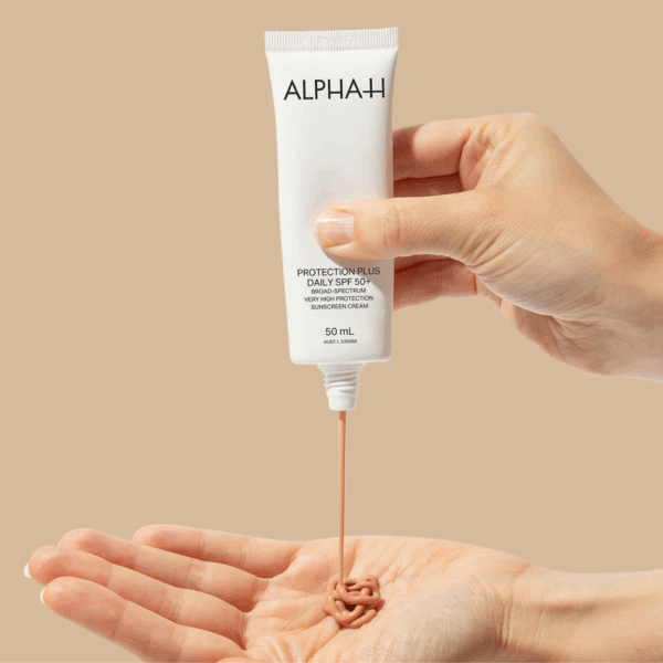 Applying Alpha-H Protection Plus Daily sunscreen, demonstrating high SPF coverage and lightweight, protective formula.