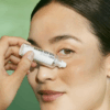 Woman applying Bioeffect Eye Serum with Refill 2 x 6ml under eye area to reduce puffiness, hydrate, and smooth fine lines.