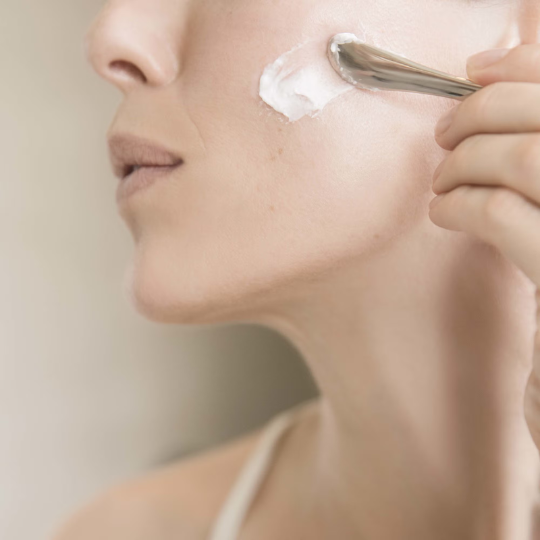 Woman applying Bioeffect EGF Power Cream 50ml to her face, highlighting the anti-ageing moisturiser and its rich texture.