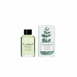 A 60ml bottle of Olverum Bath Oil featuring its minimalist design, clear green-tinted glass, and black cap.