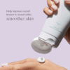Applying Exuviance Gentle Cream Cleanser to hand for texture demonstration
