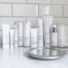 Collection of Teoxane skincare products arranged aesthetically on a neutral background, representing advanced dermocosmetic care