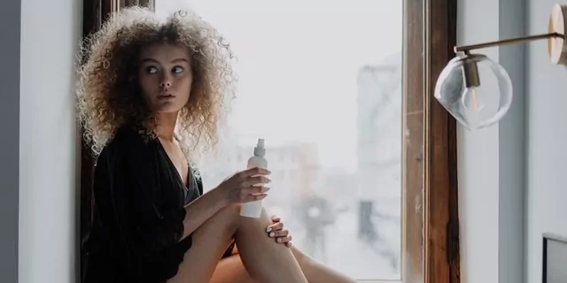 Woman applying fake tan
